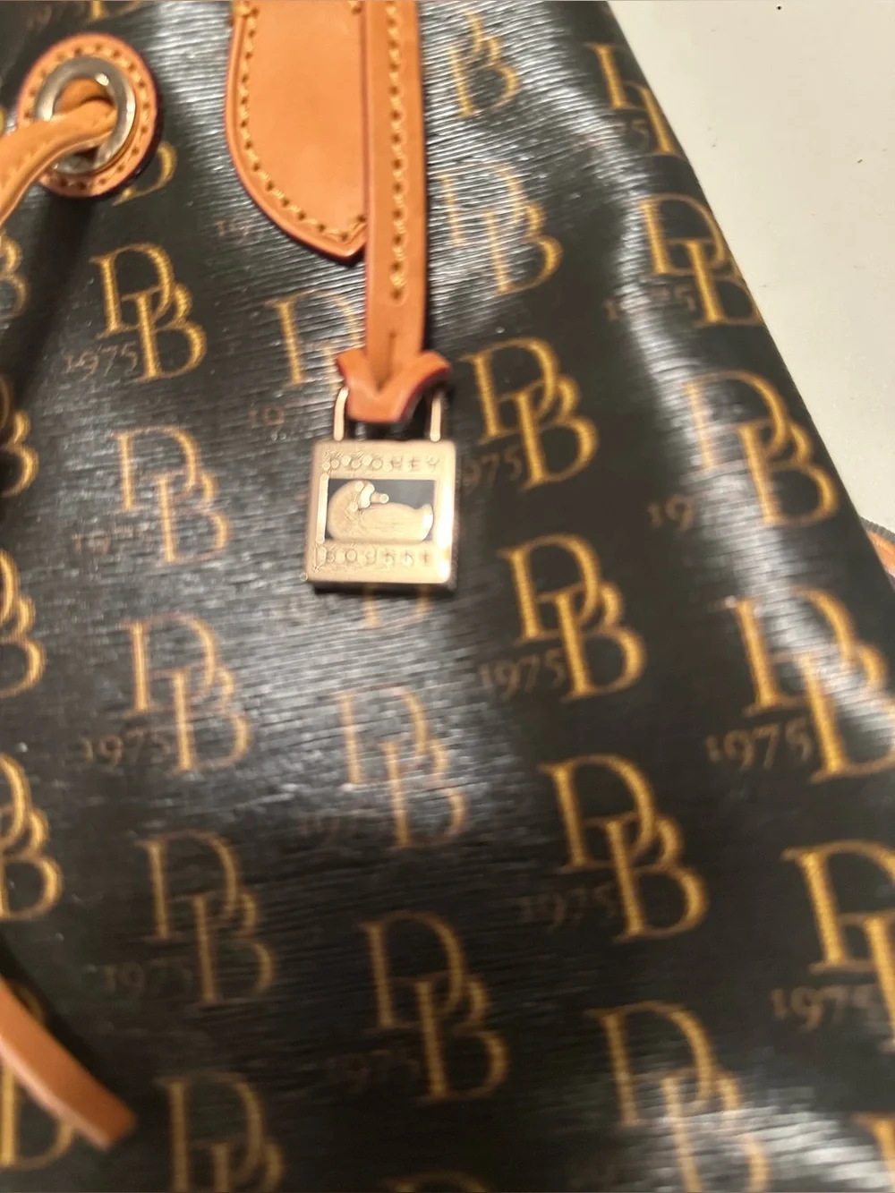 Dooney & Bourke signature brown 1975 DB logo coated canvas bucket bag